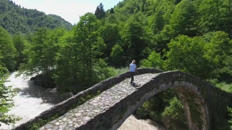 Stock Video A Woman Standing On A Bridge Over A Stream Live Wallpaper For PC - Free Live Wallpaper