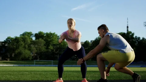 Stock Video A Trainer Helps A Woman With The Squats Training Live Wallpaper For PC - Free Live Wallpaper