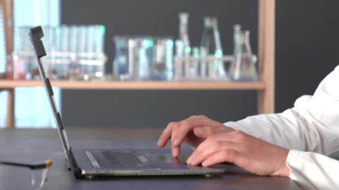 Stock Video A Scientist Typing On A Laptop In The Lab Live Wallpaper For PC - Free Live Wallpaper