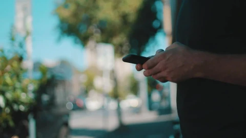Stock Video A Person In The Street Messaging On A Smartphone Live Wallpaper For PC - Free Live Wallpaper