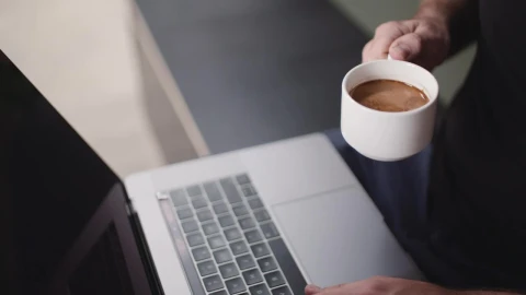 Stock Video A Person Drinking Coffee While Using A Laptop Live Wallpaper For PC - Free Live Wallpaper