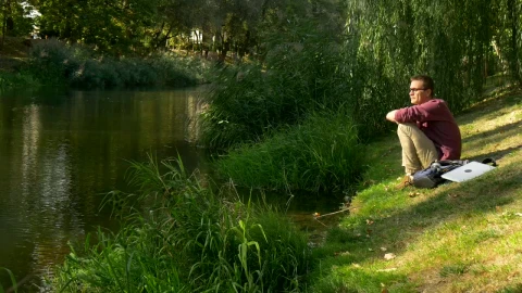 Stock Video A Man Sitting On The Riverside Thinking Live Wallpaper For PC - Free Live Wallpaper