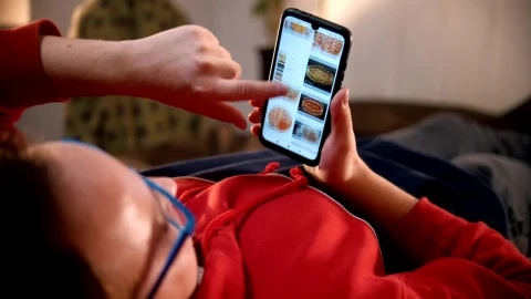 Stock Video A Man Lying On The Bed Scrolling Food Pictures On Live Wallpaper For PC - Free Live Wallpaper