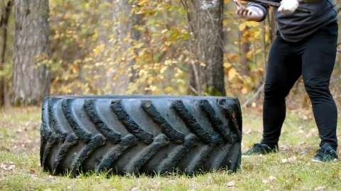 Stock Video A Man Hitting A Tire With A Mallet Live Wallpaper For PC - Free Live Wallpaper