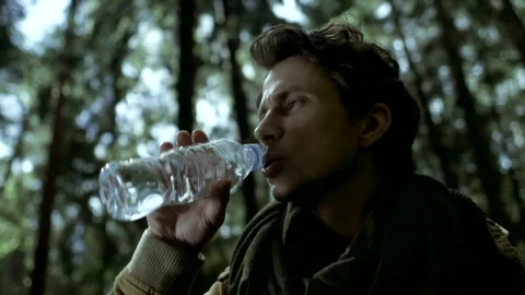 Stock Video A Man Drinks Water From A Bottle In The Woods Live Wallpaper For PC - Free Live Wallpaper