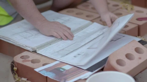Stock Video Builders Reviewing A Construction Plan Closeup Live Wallpaper For PC - Free Live Wallpaper