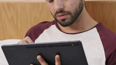 Stock Video Boy Lying Concentrated With A Tablet Before Sleeping Live Wallpaper For PC - Free Live Wallpaper