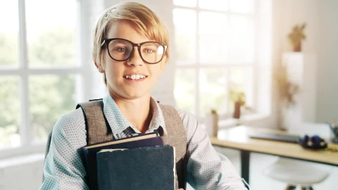 Stock Video Boy In Glasses Smiles And Holds Books In Classroom Live Wallpaper For PC - Free Live Wallpaper