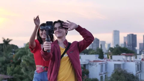 Stock Video Boy And Girl Blogging On Top With City Background Live Wallpaper For PC - Free Live Wallpaper