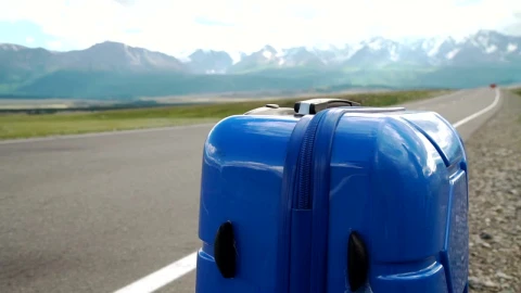Stock Video Blue Luggage Sits On The Side Of A Mountain Road Live Wallpaper For PC - Free Live Wallpaper