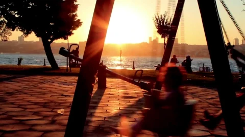 Video Stock Children Swinging In A Park Near The Coast Live Wallpaper For PC - Free Live Wallpaper