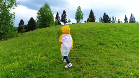 Video Stock Child Taking A Walk In The Grass Wearing A Raincoat Live Wallpaper For PC - Free Live Wallpaper