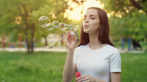 Video Stock Cheerful Girl Blowing Soap Bubbles In A Park Live Wallpaper For PC - Free Live Wallpaper
