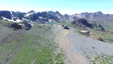 Video Stock Car And Man On A Mountain Peak Looking To The Live Wallpaper For PC - Free Live Wallpaper