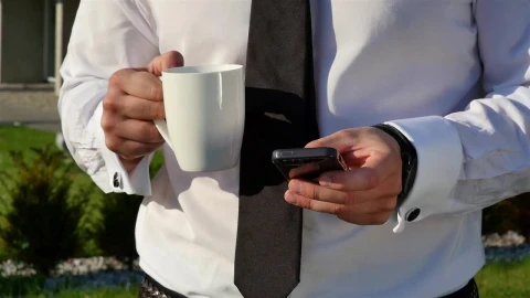 Video Stock Businessman With Coffee Mug Checking Mobile Phone Live Wallpaper For PC - Free Live Wallpaper