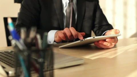 Video Stock Businessman In The Office Using His Tablet Live Wallpaper For PC - Free Live Wallpaper