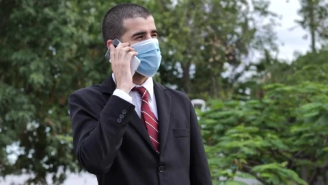 Video Stock Businessman In Suit Wearing Face Mask While Talking On The Live Wallpaper For PC - Free Live Wallpaper