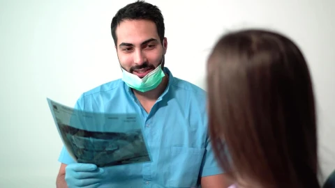 Stock Video Dentist Explaining A Tooth X Ray To A Patient Live Wallpaper For PC - Free Live Wallpaper