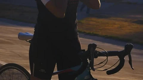 Stock Video Cyclist Girl Putting On Her Helmet Before Training Live Wallpaper For PC - Free Live Wallpaper