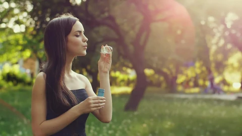 Stock Video Cute Young Woman Blowing Bubbles In The Park Live Wallpaper For PC - Free Live Wallpaper