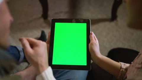 Stock Video Couple Watching Together A Tablet With Green Chroma Live Wallpaper For PC - Free Live Wallpaper