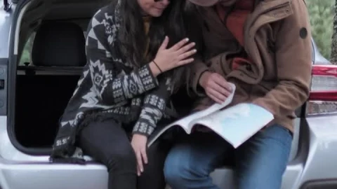 Stock Video Couple Watching A Map In The Trunk Of A Car Live Wallpaper For PC - Free Live Wallpaper