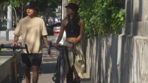 Stock Video Couple Walking With Bicycles On The Sidewalk Live Wallpaper For PC - Free Live Wallpaper