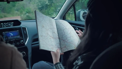 Stock Video Couple Of Adventurers Reading A Map Inside A Car Live Wallpaper For PC - Free Live Wallpaper