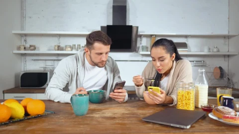 Stock Video Couple Having Breakfast Cereal And See Their Cell Phones Live Wallpaper For PC - Free Live Wallpaper