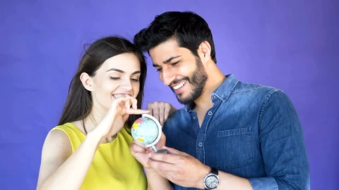Stock Video Couple Choosing A Place To Travel With A Globe Live Wallpaper For PC - Free Live Wallpaper