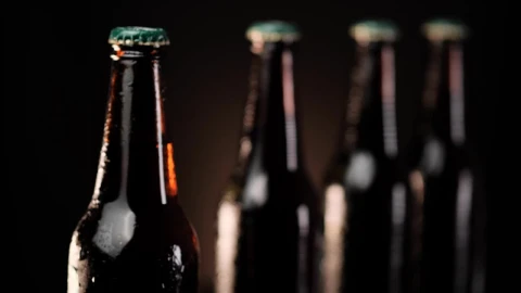 Stock Video Cold Beer Bottles In A Row On A Dark Background Live Wallpaper For PC - Free Live Wallpaper