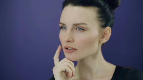 Stock Video Face Of A Young Pensive Woman On A Purple Background Live Wallpaper For PC - Free Live Wallpaper