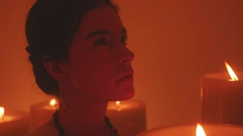 Stock Video Face Of A Spiritual Woman Meditating Among Many Candles Live Wallpaper For PC - Free Live Wallpaper