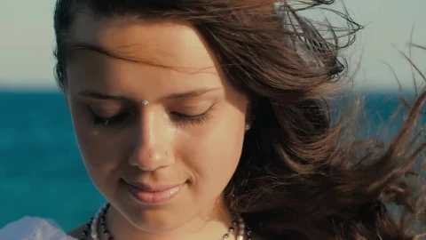 Stock Video Face Of A Cheerful Girl With Watching Near The Sea Live Wallpaper For PC - Free Live Wallpaper