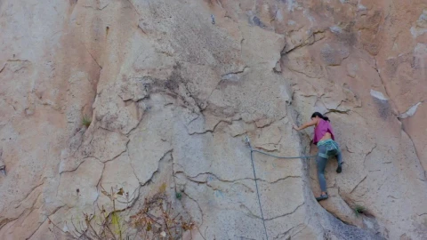 Stock Video Experienced Female Mountaineer Climbing A Vertical Mountain Live Wallpaper For PC - Free Live Wallpaper