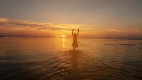 Stock Video Excited Woman Running Towards The Sunset At The Seaside Live Wallpaper For PC - Free Live Wallpaper