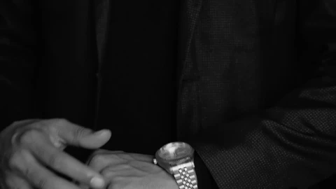 Stock Video Elegant Man In Suit Checks The Time On His Luxurious Live Wallpaper For PC - Free Live Wallpaper