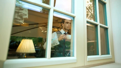 Stock Video Elegant Man Drinking From A Mug While Looking Out Live Wallpaper For PC - Free Live Wallpaper