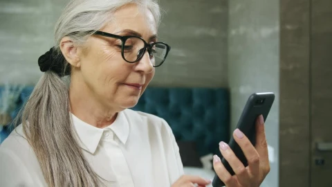 Stock Video Elderly Woman Texts On Mobile Phone And Smiles Live Wallpaper For PC - Free Live Wallpaper