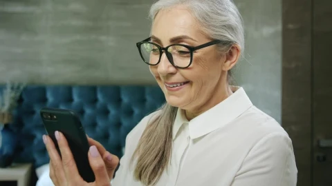 Stock Video Elderly Woman Smiles While Using Mobile App Live Wallpaper For PC - Free Live Wallpaper