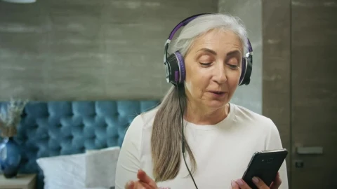 Stock Video Elderly Woman Enjoys Music App With Headphones Live Wallpaper For PC - Free Live Wallpaper