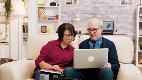 Stock Video Elderly Couple On Sofa With Laptop Shopping Online Live Wallpaper For PC - Free Live Wallpaper