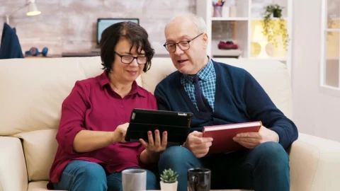 Stock Video Elderly Couple Enjoying Video Call On Sofa With Tablet Live Wallpaper For PC - Free Live Wallpaper