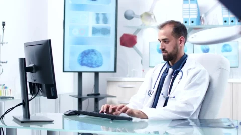 Stock Video Doctor Working In Hospital Office Is Handed Reports Live Wallpaper For PC - Free Live Wallpaper