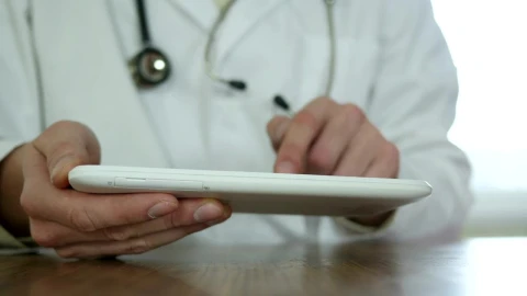 Stock Video Doctor With Gown And Stethoscope Typing On A Tablet Live Wallpaper For PC - Free Live Wallpaper