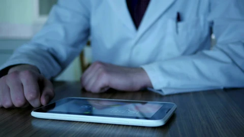 Stock Video Doctor Using A Tablet On The Desk Live Wallpaper For PC - Free Live Wallpaper