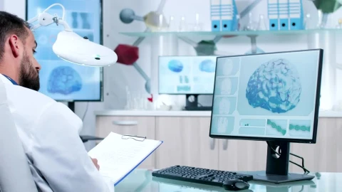 Stock Video Doctor Takes Notes While Reviewing Dna And Brain Models Live Wallpaper For PC - Free Live Wallpaper