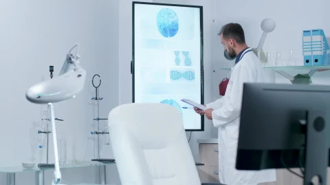 Stock Video Doctor Looks At Screen Showing Dna And Brain Models Live Wallpaper For PC - Free Live Wallpaper