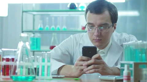 Stock Video Doctor In The Lab Looking At His Phone Live Wallpaper For PC - Free Live Wallpaper
