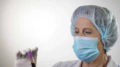 Stock Video Doctor Examining A Blood Test Wearing Mask Live Wallpaper For PC - Free Live Wallpaper